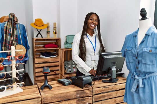 Young African American Shopkeeper Woman Smiling Happy Working At Clothing Store.