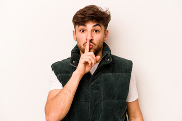 Young hispanic man isolated on white background keeping a secret or asking for silence.