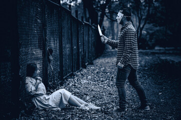 A serial killer scene is about to kill an Asian woman,concept thriller scene,Halloween festival
