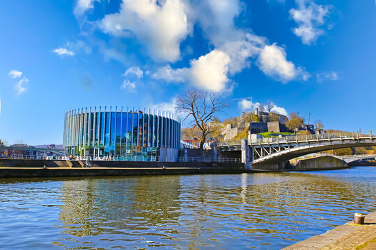 Namur, Belgium - March 9. 2022: View on confluence of river meuse and sambre with bridge, modern restaurant building, blue morning sky