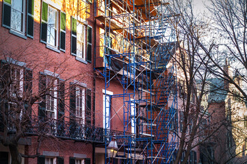classic New England Boston brownstone building with forged fire escape street view