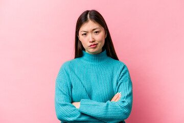 Obraz premium Young Chinese woman isolated on pink background who is bored, fatigued and need a relax day.