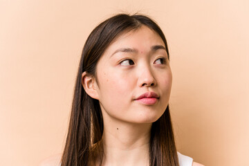Fototapeta premium Young portrait asian woman isolated on beige background
