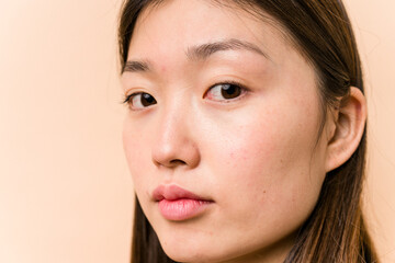 Fototapeta premium Young portrait asian woman isolated on beige background