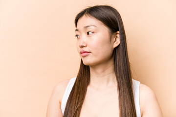 Young portrait asian woman isolated on beige background