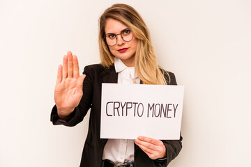 Young business caucasian woman holding a crypto money placard isolated on white background standing with outstretched hand showing stop sign, preventing you.