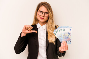 Young business caucasian woman holding a banknotes isolated on white background showing a dislike...