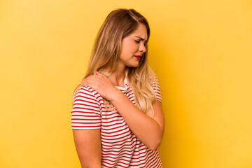 Young caucasian woman isolated on yellow background having a shoulder pain.
