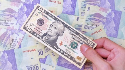 Man's hand is making a payment. Business Investment Economy Money Loan Saving Income Prosperity and Finance concept. Male hand showing dollar bills. Ten Dollar. 10 US Dollar. Money background.