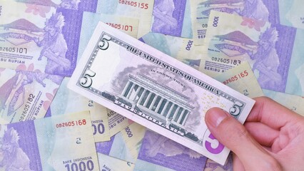 Man's hand is making a payment. Business Investment Economy Money Loan Saving Income Prosperity and Finance concept. Male hand showing dollar bills. Five Dollar. 5 US Dollar. Money background.