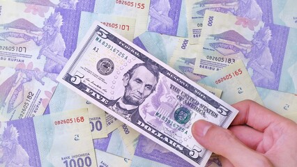 Man's hand is making a payment. Business Investment Economy Money Loan Saving Income Prosperity and Finance concept. Male hand showing dollar bills. Five Dollar. 5 US Dollar. Money background.