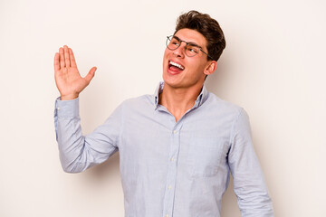 Young caucasian man isolated on white background dancing and having fun.