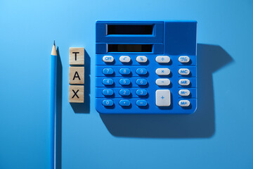 calculator and single word tax on the blue background