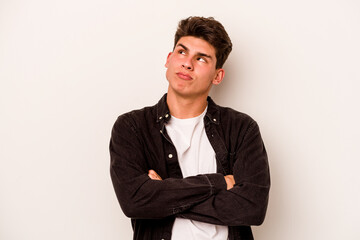 Young caucasian man isolated on white background dreaming of achieving goals and purposes