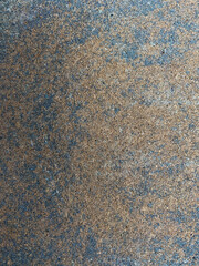 Multicolored Concrete rock from a retaining  wall with grey, black, and orangish colors 
