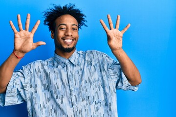 Young african american man with beard wearing casual clothes showing and pointing up with fingers...