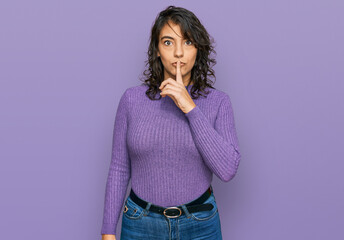 Young hispanic woman wearing casual clothes asking to be quiet with finger on lips. silence and secret concept.