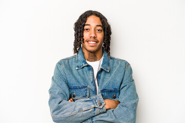 Young African American man isolated on white background who feels confident, crossing arms with determination.