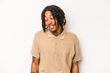 Young African American man isolated on white background laughs and closes eyes, feels relaxed and happy.