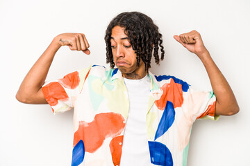 Young African American man isolated on white background showing strength gesture with arms, symbol of feminine power