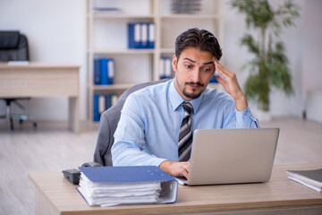 Young male employee working in the office