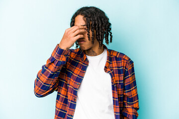 Young African American man isolated on blue background having a head ache, touching front of the face.