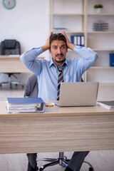 Young male employee working in the office