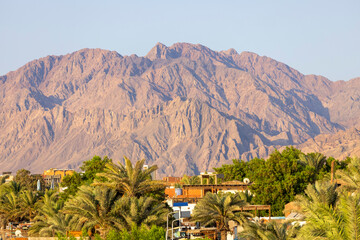 Aerial view of exotic small town on the Red Sea surrounded by the picturesque mountains of the Sinai Peninsula, Dahab, Egypt