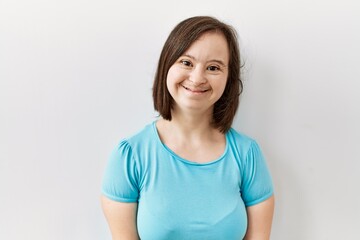 Obraz premium Young down syndrome woman standing over isolated background with a happy and cool smile on face. lucky person.