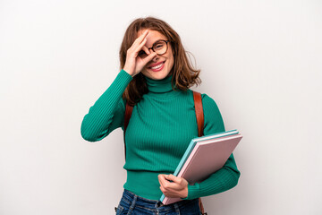 Young student caucasian woman isolated on white background excited keeping ok gesture on eye.