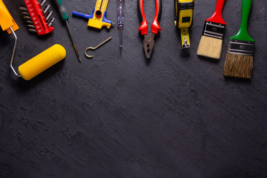 Construction tools on black slate background. Construction concept