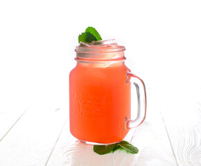 Cold strawberry lemonade in mason jar isolated