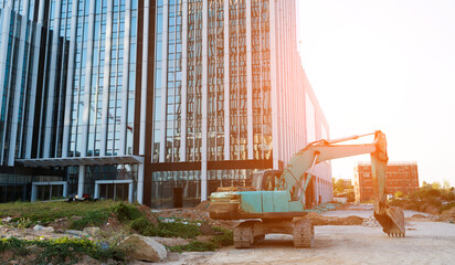Excavator on construction site office building