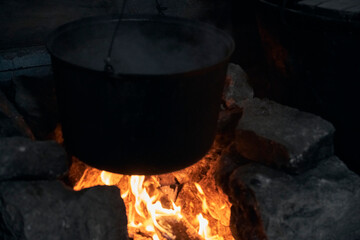  a burning hearth in the house and a cooking pot