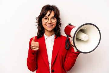 Young business hispanic woman holding an megaphone isolated on white background smiling and raising thumb up