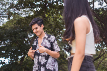 A cute young guy being shy. Noticing the girl in the park. Interested to know the person but...