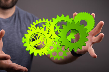 Mechanism green gears and cogs at work on black background. Industrial machinery