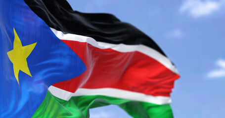 Detail of the national flag of South Sudan waving in the wind on a clear day