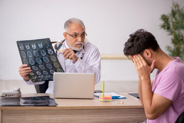 Young male patient visiting old male doctor radiologist