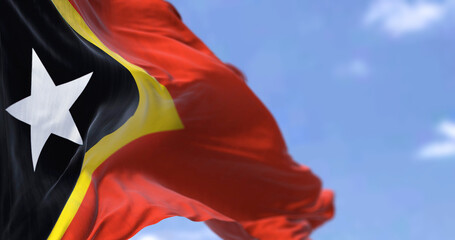 Detail of the national flag of East Timor waving in the wind on a clear day