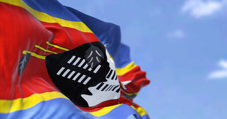 Detail of the national flag of Eswatini waving in the wind on a clear day.