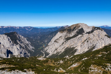 Fototapeta na wymiar Panoramic view on the mountain peaks of the Hochschwab Region in Upper Styria, Austria.Summit of Riegerin in the beautiful Alps in Europe. Climbing tourism, wilderness. Concept freedom. Brunnsee