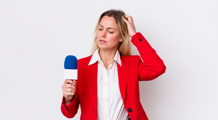 blonde pretty woman smiling happily and daydreaming or doubting. preporter and microphone concept