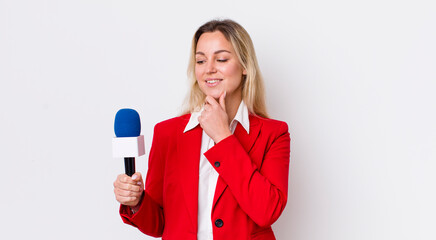 blonde pretty woman smiling with a happy, confident expression with hand on chin. preporter and...
