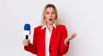 blonde pretty woman amazed, shocked and astonished with an unbelievable surprise. preporter and...