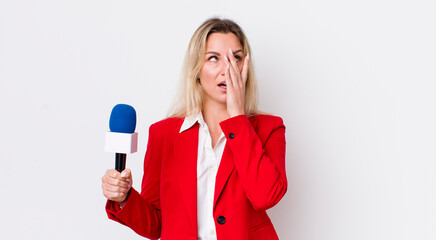 blonde pretty woman feeling bored, frustrated and sleepy after a tiresome. preporter and microphone...