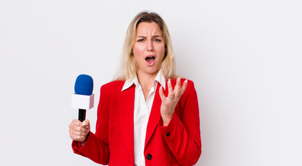 blonde pretty woman looking desperate, frustrated and stressed. preporter and microphone concept