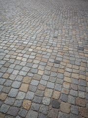cobblestone surface of a city square. 
gray paved road or driveway.
