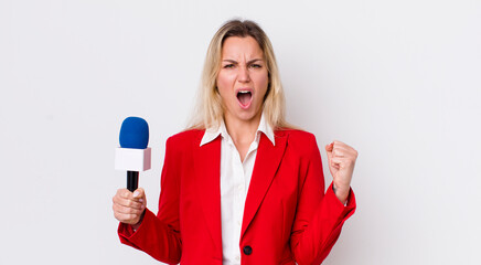 blonde pretty woman shouting aggressively with an angry expression. preporter and microphone concept