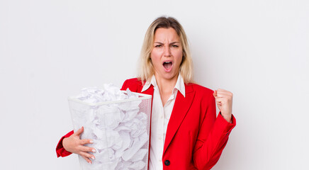 blonde pretty woman shouting aggressively with an angry expression. paper balls mistakes concept